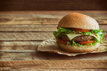 Homemade hamburger on plaid napkin with french fries. Delicious sandwich hamburger with meat or...