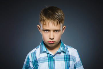 angry boy isolated on gray background. Closeup
