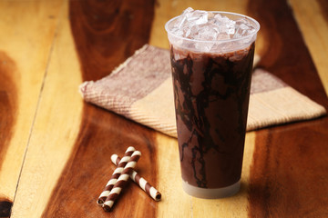Ice cocoa soft drink on wood floor and topping