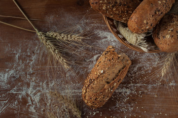 Bread with sesame and flax seed on rustic wooden table