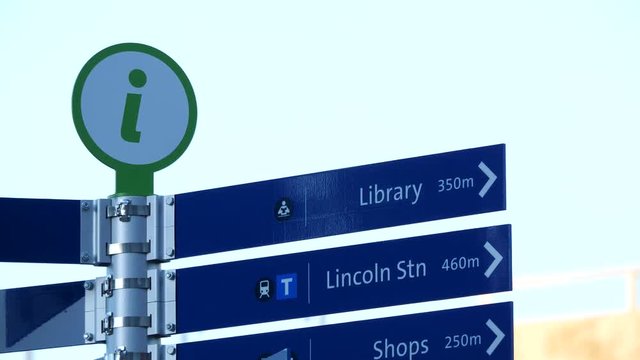 Motion of city direction information sign with blur skytrain passing background
