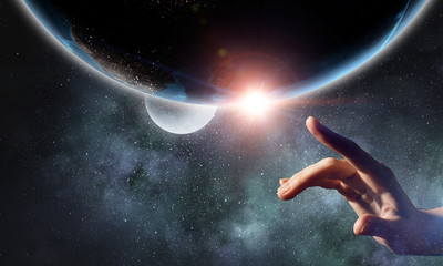 Touching planet with finger