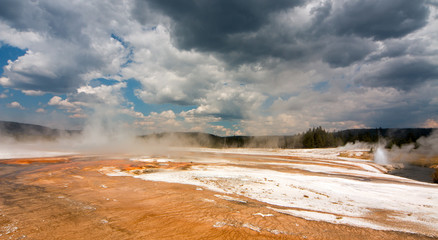 Rainbow Pool hot spring run off past the Cliff Geyser into Iron Spring Creek in Black Sand Basin in...