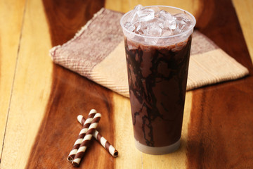 Ice cocoa soft drink on wood floor and topping