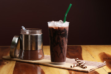 Ice cocoa soft drink on wood floor and topping