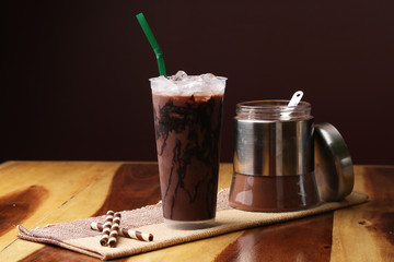 Ice cocoa soft drink on wood floor and topping