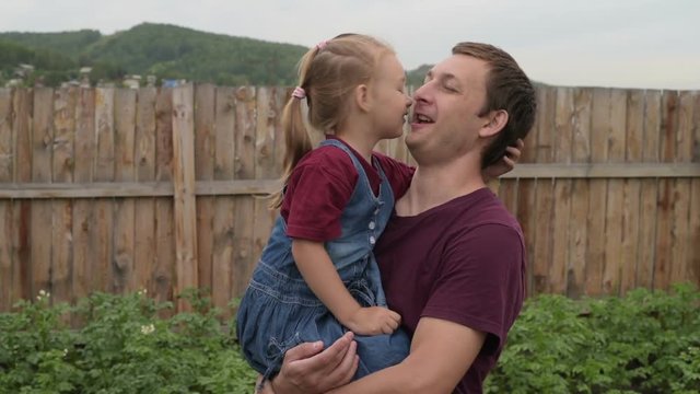 Father and daughter rubbing their noses