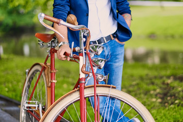 Naklejka na ściany i meble Close up image of a man on a retro bicycle.
