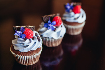 Beautiful and tasty muffins with raspberries and flowers