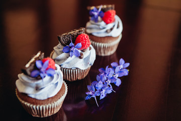 Beautiful and tasty muffins with raspberries and flowers