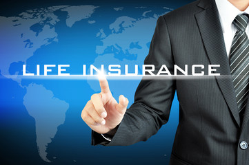 Businessman touching LIFE INSURANCE sign on virtual screen