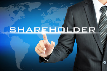 Businessman pointing to SHAREHOLDERS sign on virtual screen