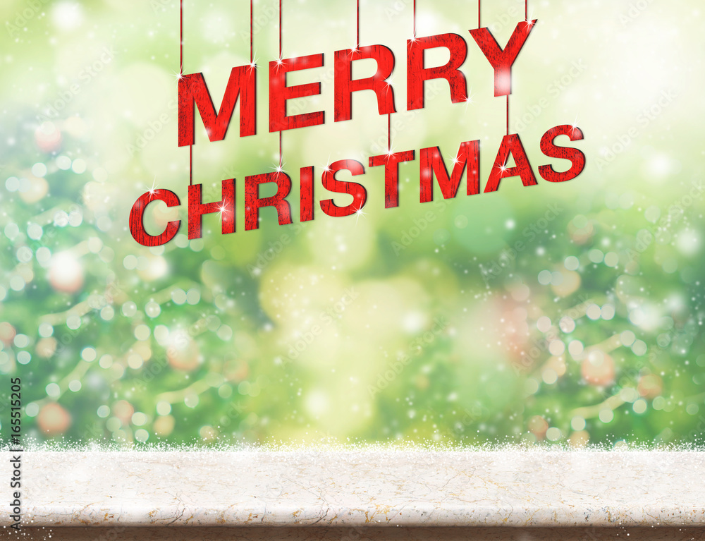 Poster merry christmas red text hanging over marble table with blur christmas tree green background,holiday