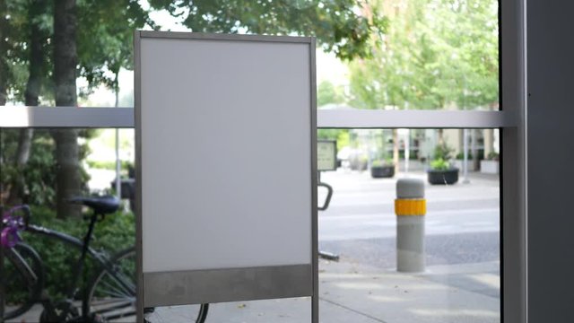 Motion of white billboard  for your ad beside of mall entrance with 4k resolution.