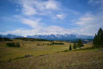 Scenic landscape of snow peaks of North-Chiyski ridge and Kurai steppe in Altai mountains. Altay Republic, Siberia, Russia.