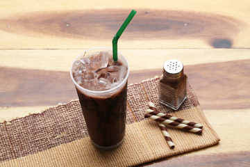 Ice cocoa soft drink on wood floor and topping
