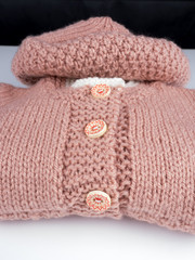 Baby hat and vest on white background