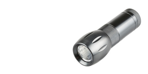 Metal flashlight over white background