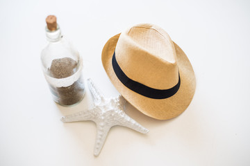 Starfish and a hat on a white table, concept of summer vacations