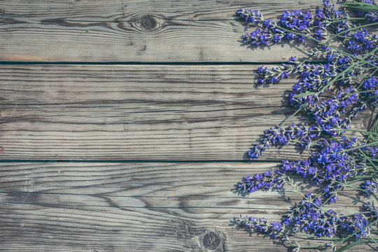 Lavender flowers from right side of wooden  background top view