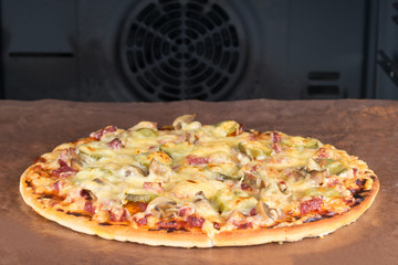 round pizza out of the oven on a Teflon surface