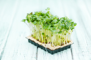 Cress (selective focus) on vintage wooden background