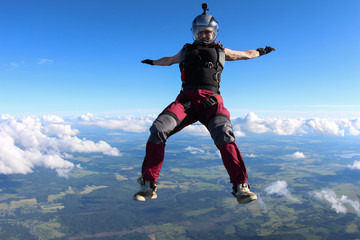 Fototapeta na wymiar Girl skydiver is in the sky