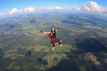 Obraz premium Girl skydiver is in the sky