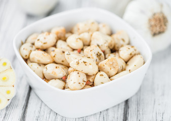 Preserved Garlic (selective focus) on vintage wooden background
