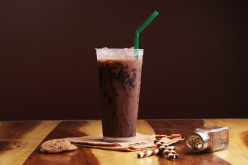Ice cocoa soft drink on wood floor and topping