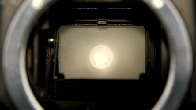 Camera shutter aperture transition in slow motion. Closeup camera lens