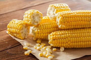 fresh corn on wooden table