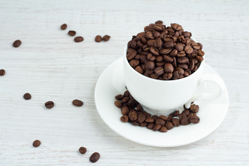 Coffee beans in a cup top view.