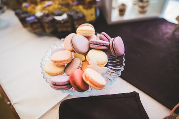 Delicious sweets on wedding candy buffet with desserts, cupcakes