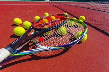 Tennis balls and racket on the grass court