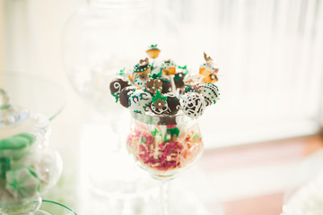 Delicious sweets on wedding candy buffet with desserts, cupcakes