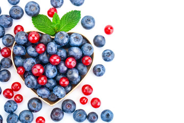 a bunch of fresh berries on a white background. Ripe Sweet Blueberry and red Currant.