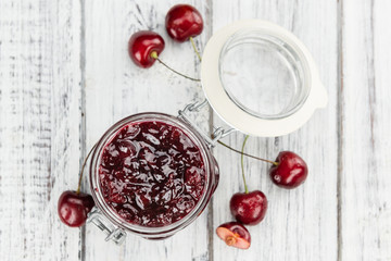 Fresh made Cherry Jam on a rustic background
