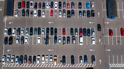 Aerial view of parking lot with many cars from above, transportation and urban concept
