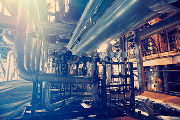 Equipment, cables and piping as found inside of a modern industrial power plant