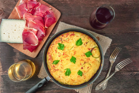 Spanish tortilla in tortillera, with wine, jamon, and cheese