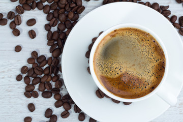 Espresso coffee close-up top view over white background.