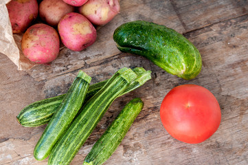 Vegetables on the table: potatoes, zucchini, cucumber, tomato