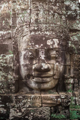 Stone faces on the towers of ancient Bayon Temple in Angkor Thom, Cambodia