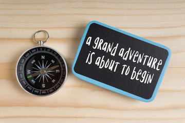 Travel inspirational quote with phrase ‘a grand adventure  is about to begin’.