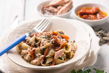 pasta with tuna dried tomatoes and capers, selective focus