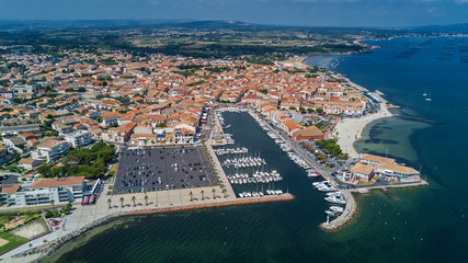 Fototapeta premium Aerial top view of boats and yachts in marina from above, harbor of Meze town, South France 