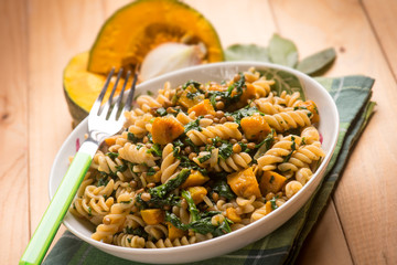 Pasta with spinach and pumpkin, selective focus