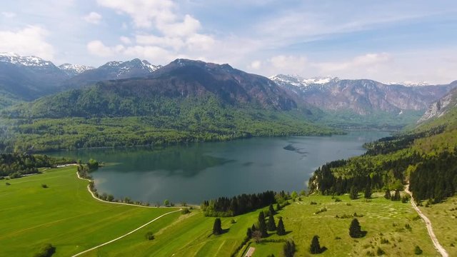 Aerial view on Bohinjsko jezero between mountains in Slovenia at spring, 4k
