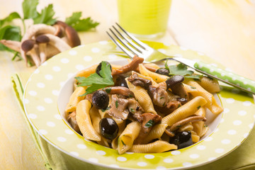pasta with mushroom and black olives, selective focus